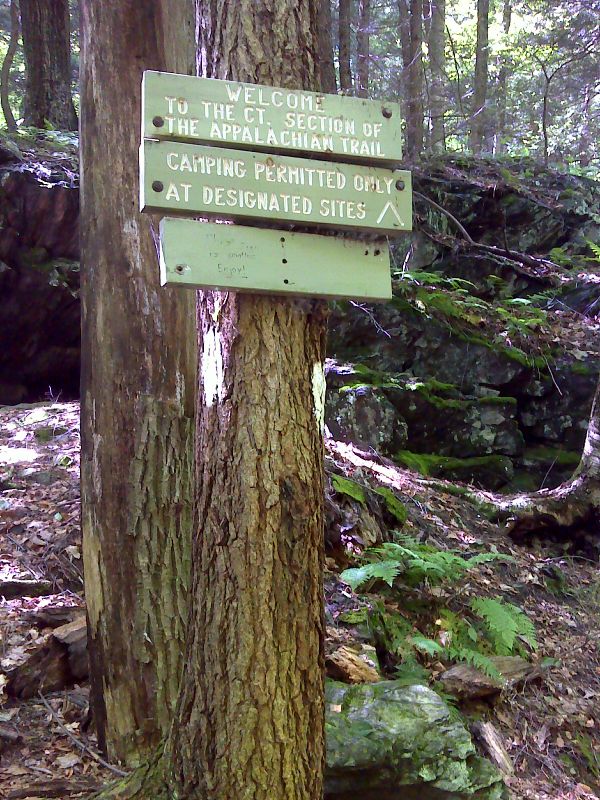 mm 0.0  Sign on the south side of the Sages Ravine Brook crossing.  Even though the ravine is actually in Massachusetts, this crossing has traditionally been the dividing line between the sections maintained by the CT chapter of the Appalachian Mountain Club (to the south) and the Berkshire chapter of the AMC (to the north).  Thus the Welcome to Connecticut sign.   GPS N42.0524 W 73.4440  Courtesy pjwetzel@gmail.com