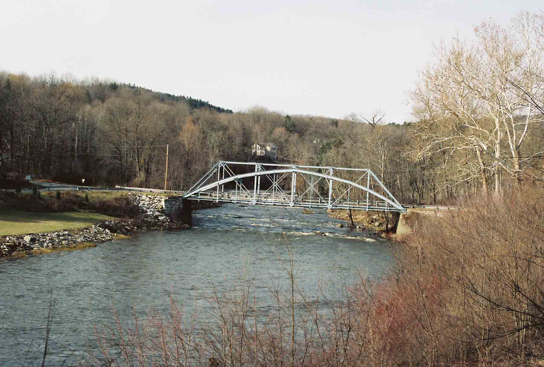 The Iron Bridge near Falls Village. The trail crosses the Housatonic River on this bridge.  A corner of the  boat launch area where there is ample parking can be seen on the left (west) bank. There is ample parking there. The bridge is at MM 8.2. Update: The bridge is currently (May 2012) closed to vehicle traffic, but still can be used by hikers. Courtesy dlcul@conncoll.edu