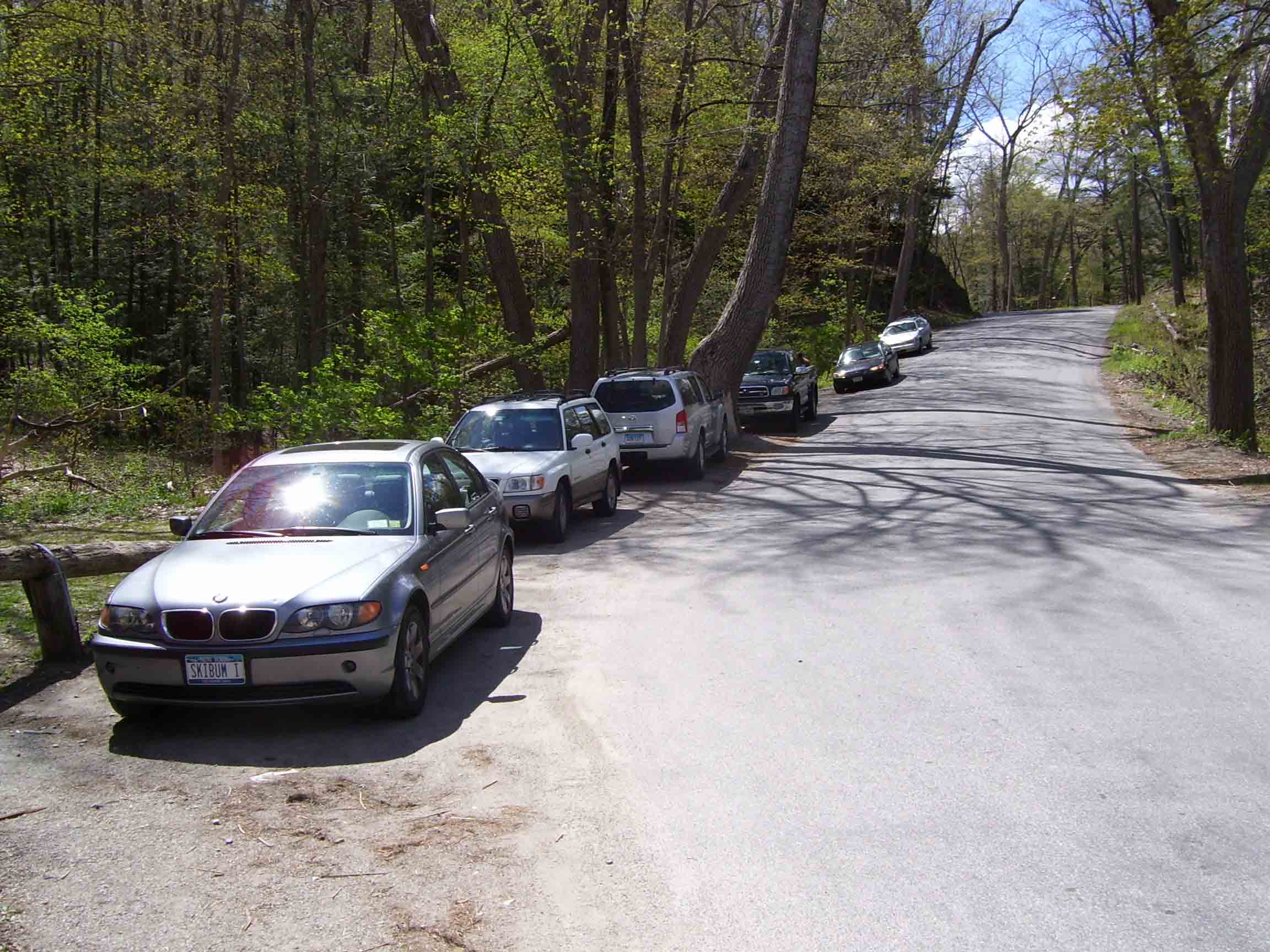Roadside parking along Bulls Bridge Road. Formerly the trail came in from the left, went along Bulls Bridge Road to the junction of Schagiticoke Road. The new trail goes over a hill to the junction. The former AT route is now a blue-blazed route which meets the AT at MM 7.9  Alternatively the road may be followed over the rise in picture to meet AT at MM 7.4. Update (2013): Because of overuse of the sort seen in this photo, roadside parking is prohibited along Bulls Bridge Road from US 7 to the junction with Schaghticoke Road.  Courtesy dlcul@conncoll.edu