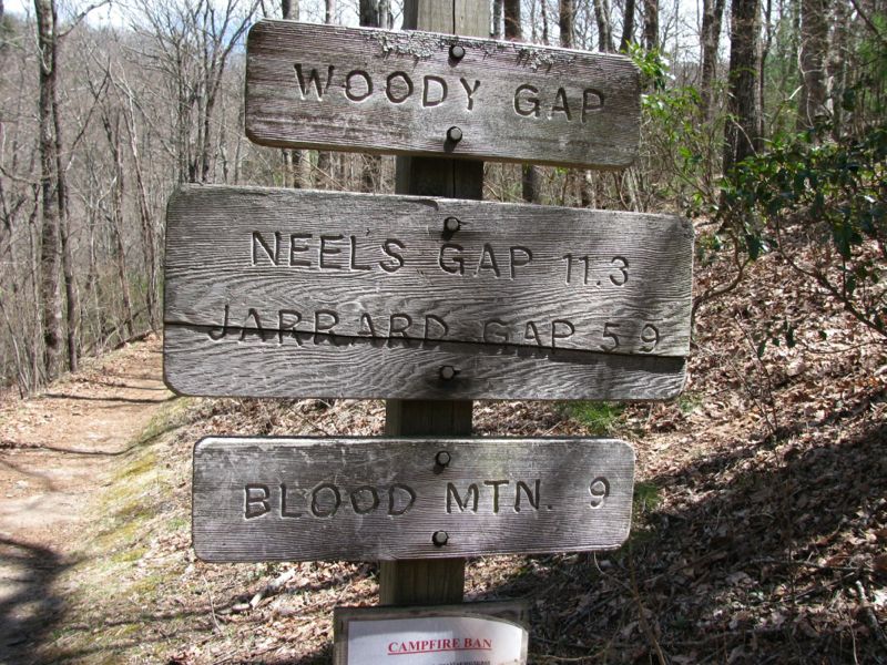 mm 10.6 The sign at Woody Gap looking north on the AT showing the miles to Jarrard Gap, Blood Mt. and Neels Gap.   Courtesy commissar67@gmail.com