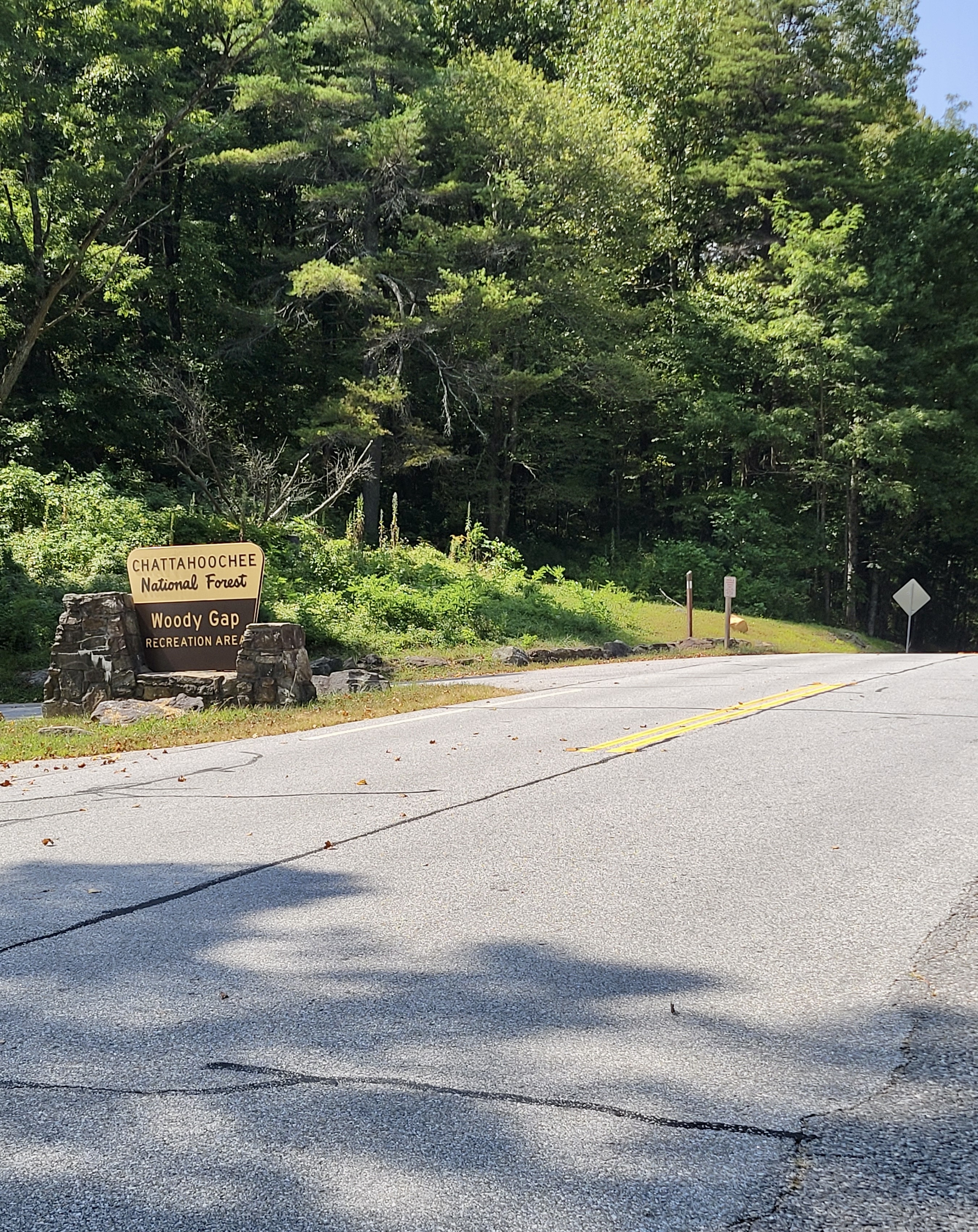 mm 0.0 Woody Gap Forest Service Sign. Zoom in on center of photo to see wooden post with white blaze showing where AT crosses GA 60.  Courtesy cabincellars@yahoo.com