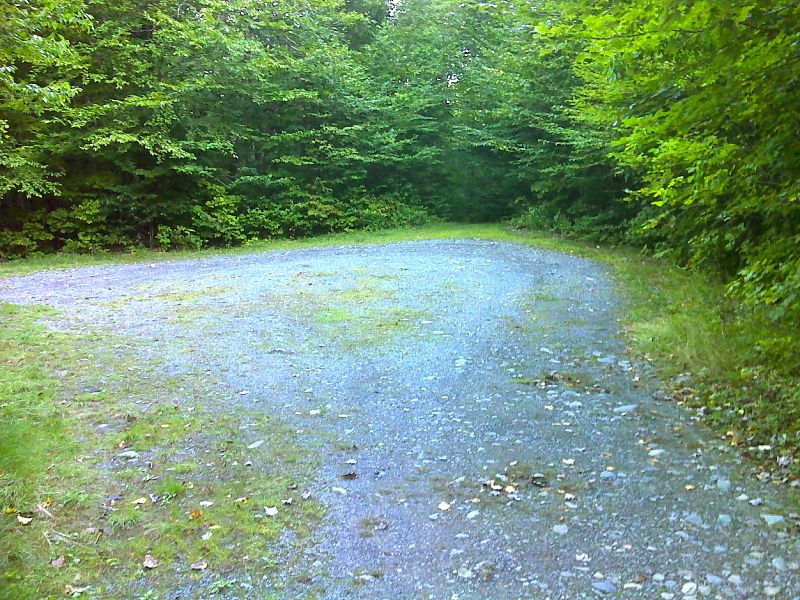 mm 15.2 End of road for Otter Pond Access route.  Trail enters the woods here and climbs 0.8 miles to the AT.   GPS N45.4135 W69.4168  Courtesy pjwetzel@gmail.com