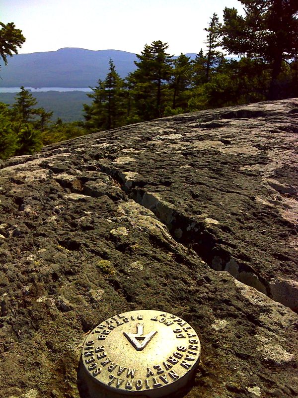 mm 29.7  Survey marker on summit of Pleasant Pond Mt.  Moxie Pond and Moxie Bald are in  distance. This marker is about 50 feet off the trail.   GPS  N45.2721 W 69.8952  Courtesy pjwetzel@gmail.com
