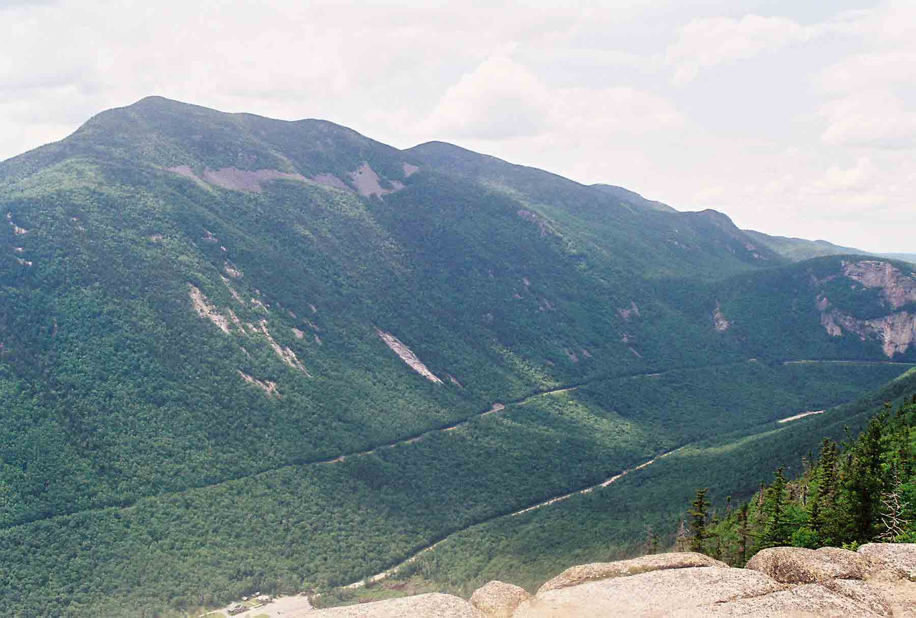 View across Crawford Notch. The peak on the left is Mt. Willey. The one to its right is probably Mt. Field.  Courtesy dlcul@conncoll.edu