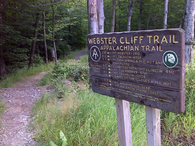 mm 26.0 Trail  sign as the northbound AT leaves US 302 in Crawford Notch State Park. The AT follows the Webster CLiffs Trail northbound from here to Mt. Pierce.  GPS 44.1709 N71.3874  Courtesy pjwetzel@gmail.com