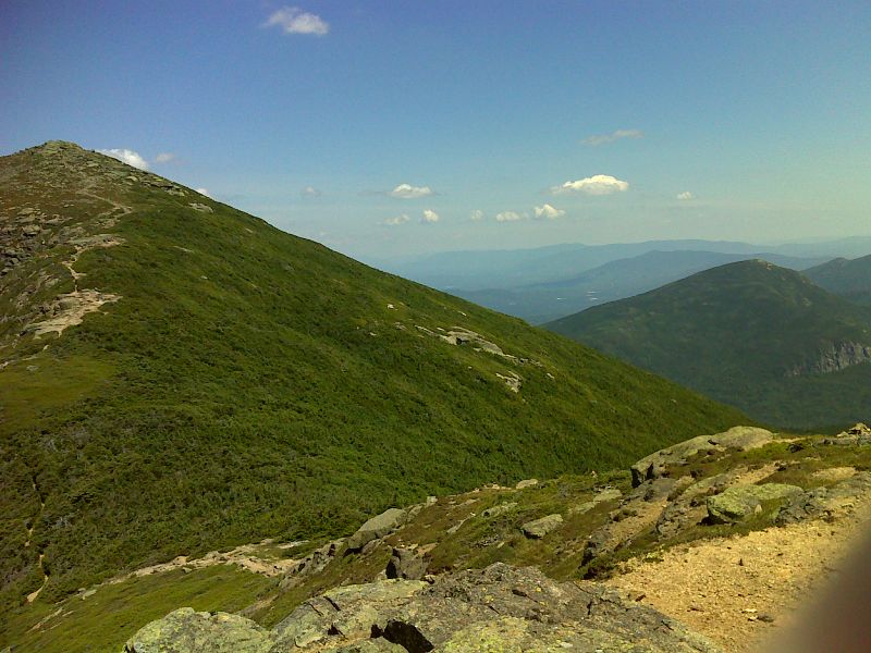 View of Mt. Lafayette (on left) and Mt. Garfield (on right) from Franconia Ridge.  Taken from approx. mm 21.9 . GPS N44.1548 W71.6438  Courtesy pjwetzel@gmail.com