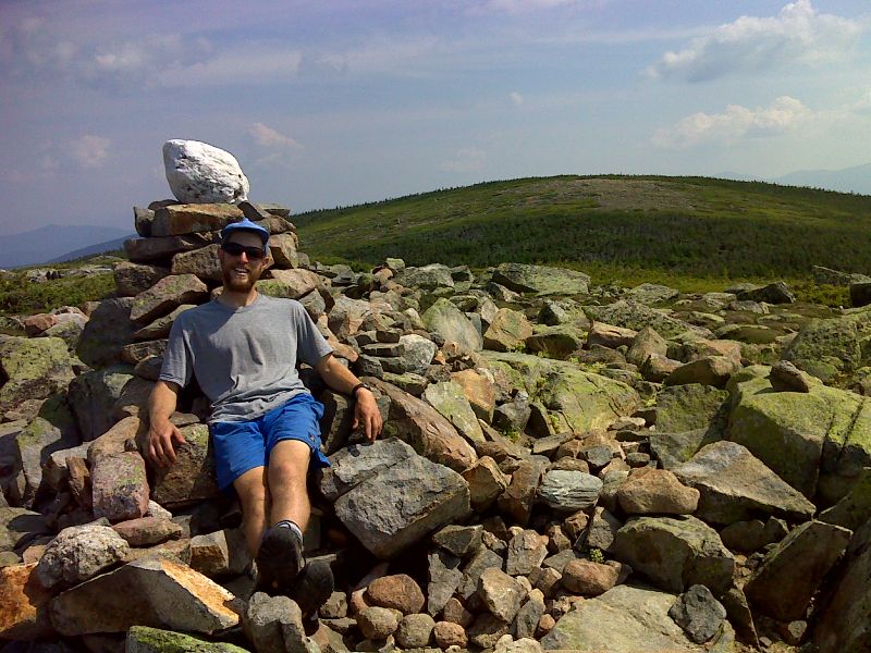 mm 11.9 Caretaker for Guyot Shelter (2012) working on a cairn with a built in chair.  This is on the Bondcliff Trail.   GPS N44.1661 W71.5366  Courtesy pjwetzel@gmail.com