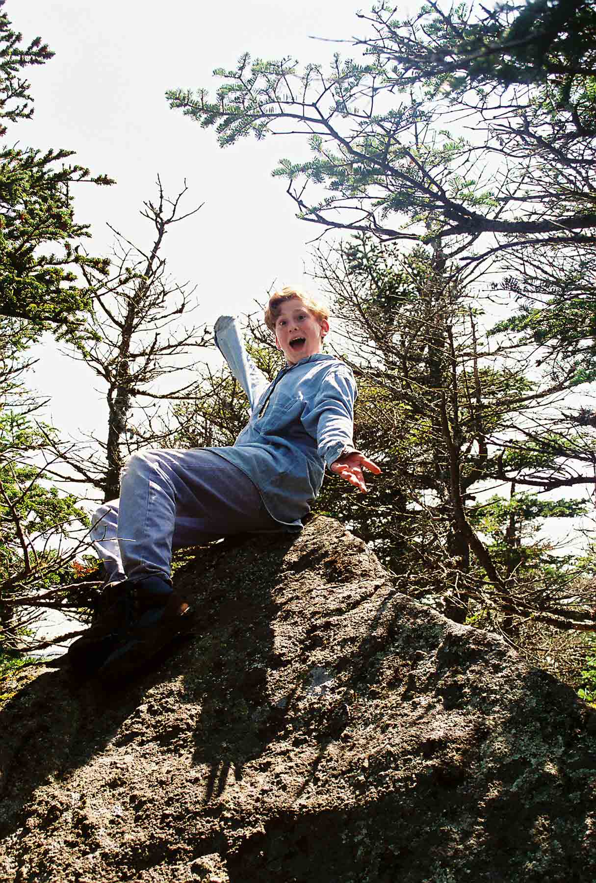 mm 5.4 - My son, Mike, then 13 (1994) on the official summit of North Kinsman Mt. This rock is considered the actual high point of the mountain.  Courtesy dlcul@conncoll.edu