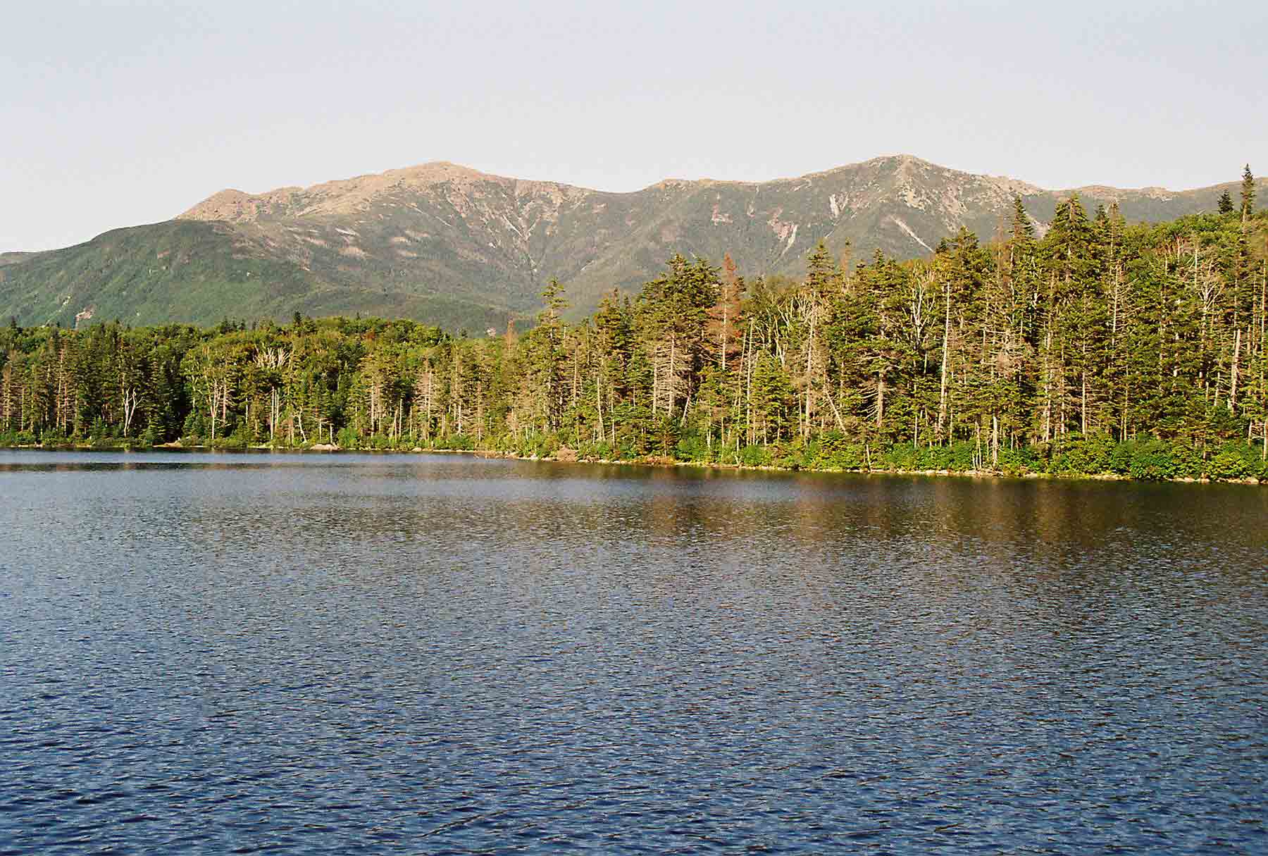mm 2.9 - View across Lonesome Lake to the Franconia Range from near Lonesome Lake Hut. Largest peak is Mt. Lafayette.  Courtesy dlcul@conncoll.edu