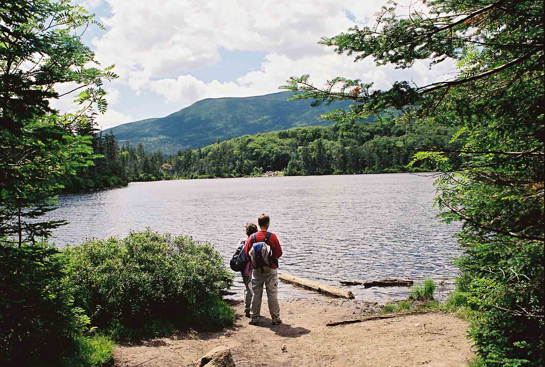 Lonesome Lake from northeast end. Taken from blue-blazed Lonesome Lake Trail. AT runs along far (south) shore. (July '04). Courtesy dlcul@conncoll.edu