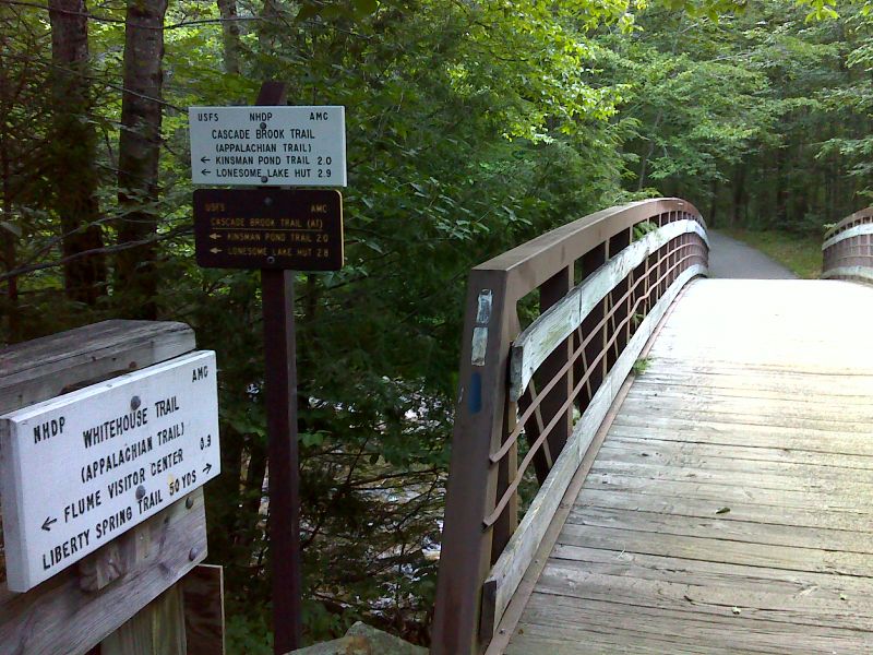 mm 0.0  Trailhead for the Cascade Brook Trail in Franconia Notch.  The southbound AT follows the Cascade Brook Trail.  The northbound AT goes straight ahead on the bike path across the bridge, then turns onto the Liberty Spring Trail.    GPS N 44.1098 W71.6815  Courtesy pjwetzel@gmail.com