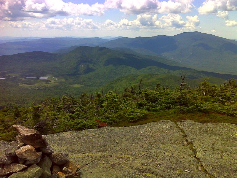 mm 6.3 Mt. Moosilauke (on right), Mt. Wolf (in center) and Bog Pond (on left) from summit of South Kinsman. GPS N44.1219  W71.7398  Courtesy pjwetzel@gmail.com