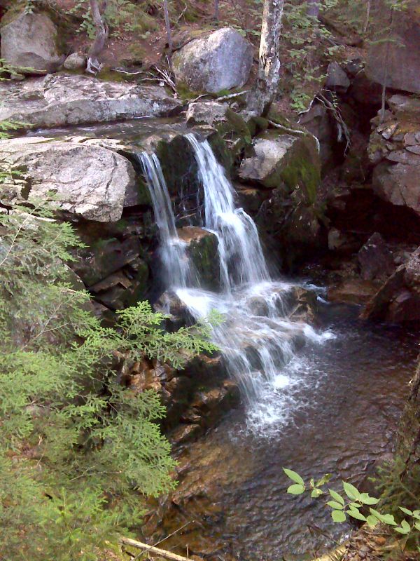 At approximately mm 0.3, the trail crosses Whitehouse Brook.  It is a short bushwhack downstream to this waterfall.    GPS N 44.1138 W71.6842  Courtesy pjwetzel@gmail.com
