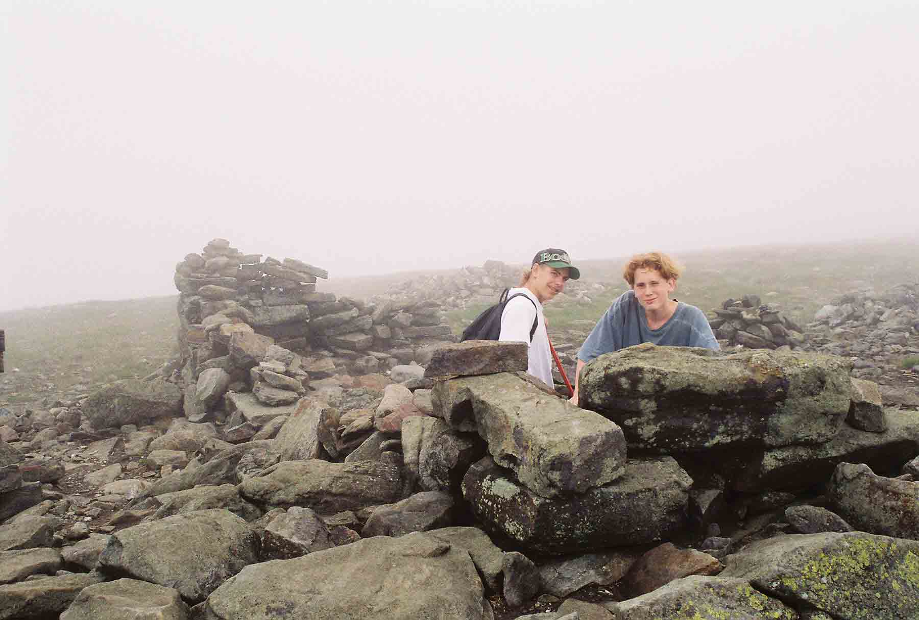 My son Mike (on right), then 14 (1995) with his friend Aaron taking refuge in the foundations of the old hotel which once was on the summit of Mt. Mooilauke.     Courtesy dlcul@conncoll.edu