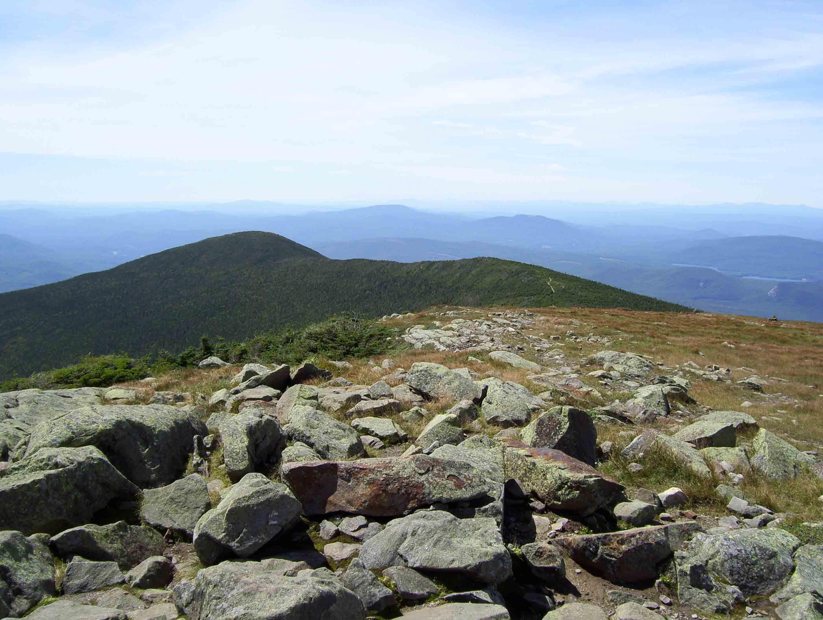 View to the south along the Moosilauke ridge. The peak at the end of the ridge is the South Peak. The AT follows the ridge, then on the north side of the South Peak, turns right and descends over 3000 feet to Glencliff.   Courtesy dlcul@conncoll.edu