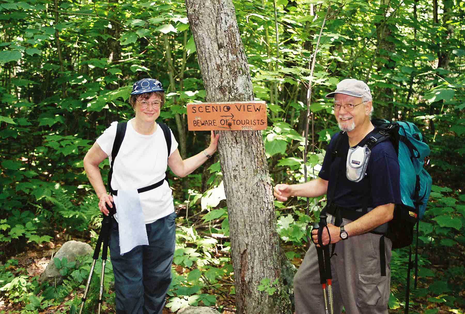 'Tourists' Barry and Marsha near viewpoint on N side of Mt. Mist. The Dartmouth Outing Club which maintains this sections has signs like this throughout its section, e.g. 'No Unicycles'. Taken at  approx. Mile 2.4.  Courtesy dlcul@conncoll.edu
