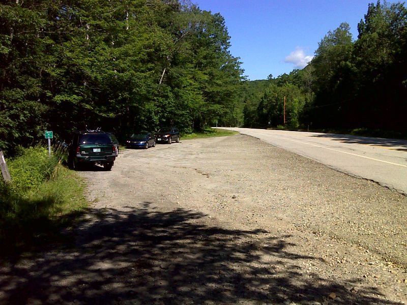 mm 0.0 Large parking area on NH 25. The northbound trail follows the road to almost the end of the parking area, then goes right into the woods and immediately crosses Oliverian Brook.     GPS  N43.9897 W71.8992  Courtesy pjwetzel@gmail.com