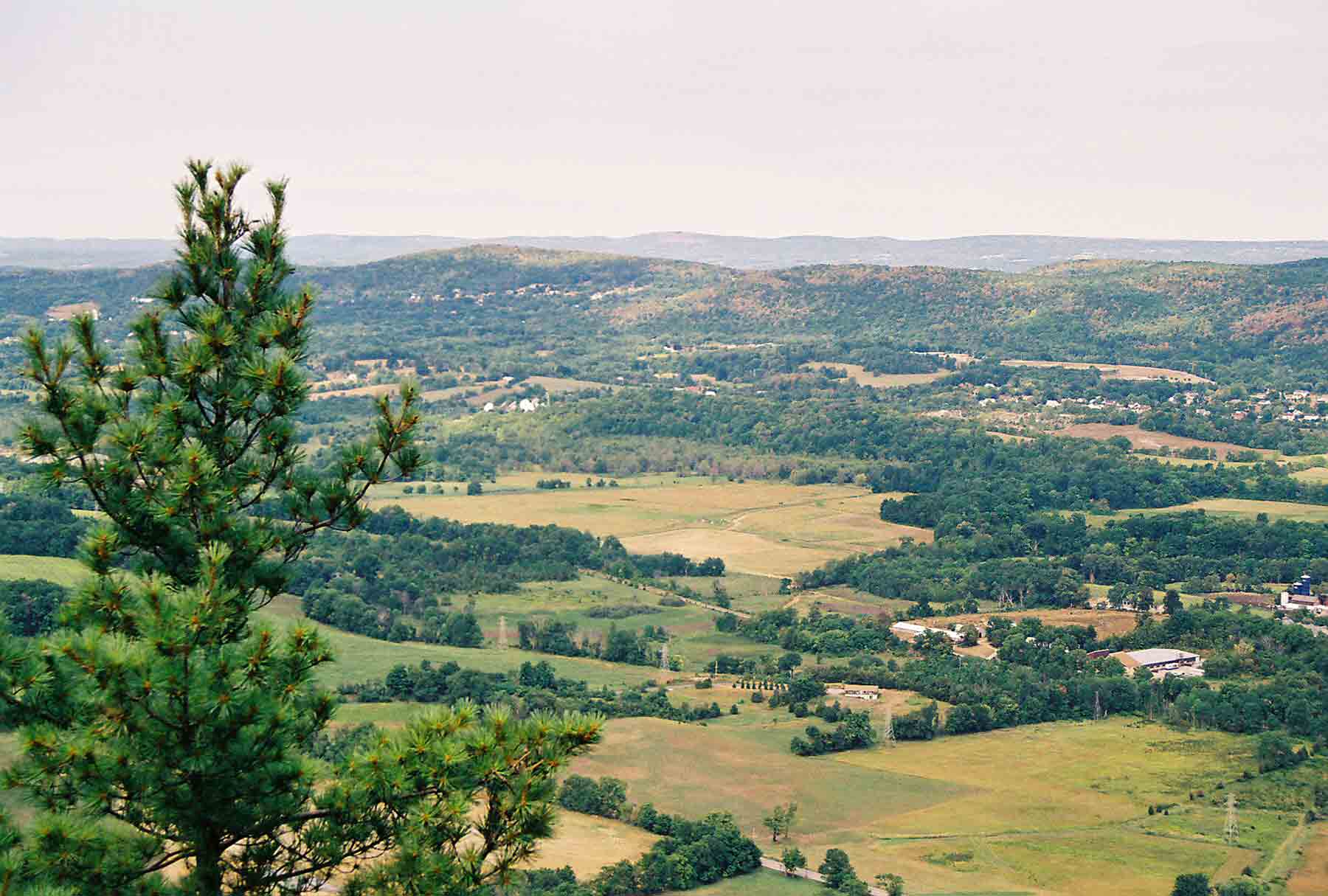 mm 7.8 - View west from Pinwheel's Vista. The closer range of mountains is Pochuk Mt., the more distant range is the Kittatiny Mts.  Courtesy dlcul@conncoll.edu
