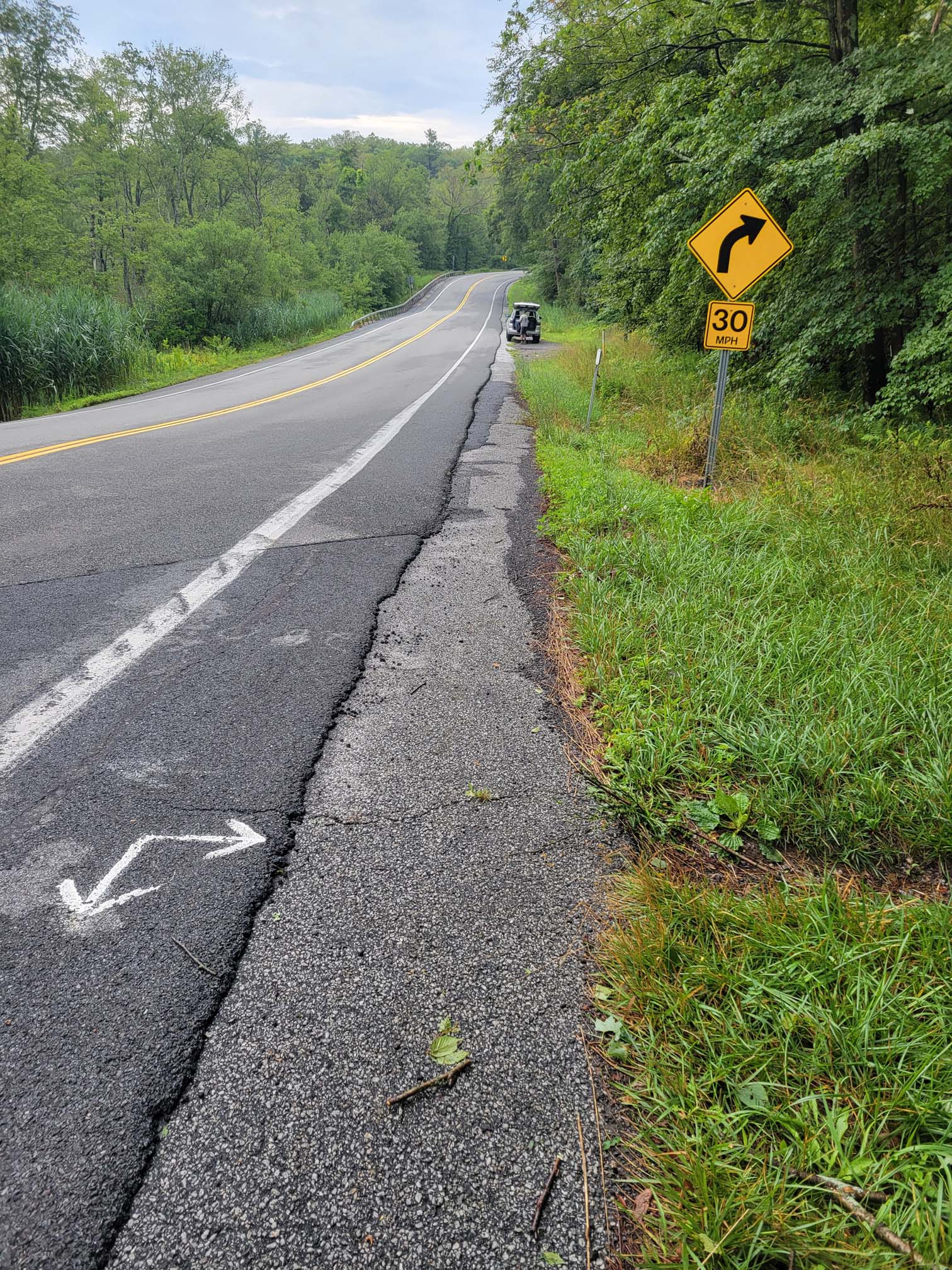 mm 1.8 notice pull off parking in the distance. Arrows direct you to trailheads.   Courtesy cabincellars@yahoo.com