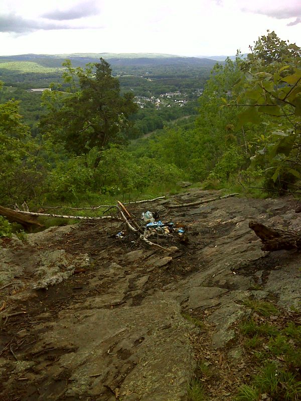 mm 3.4 Grab some Buds.  There is a great view from this ledge, which is the highest point the trail reaches on West Mountain. It is unfortunately spoiled by trash left behind by partiers (May 2012).  GPS N41.6071 W73.6186  Courtesy pjwetzel@gmail.com