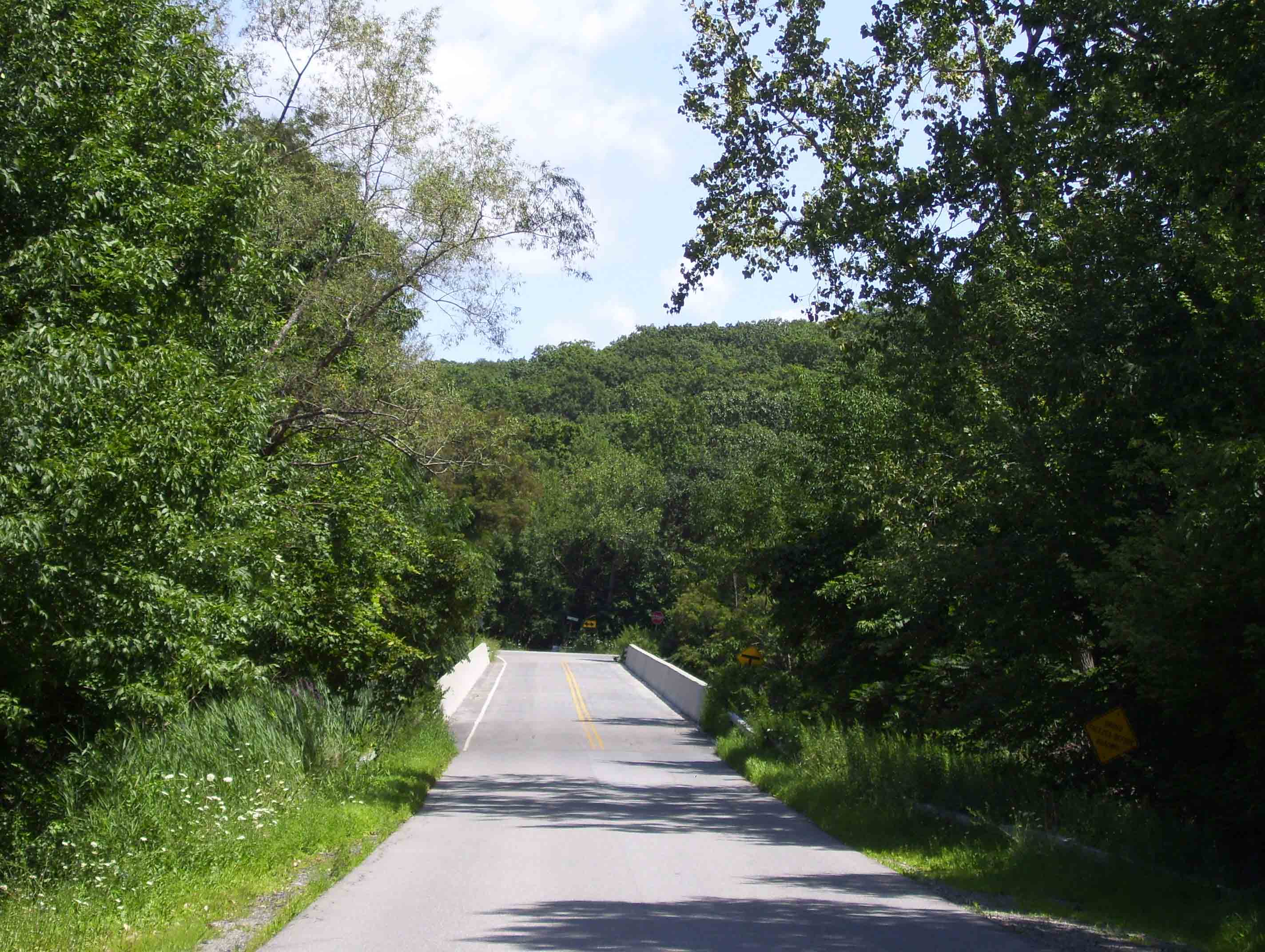 Stormville Mountain Road. The northbound trail follow this across the bridge over I-84, then continues straight ahead into the woods at the T intersection (Stormville Mountain Road and Grape Hollow Road) on the other side. Taken from approx. mm 6.0   Courtesy dlcul@conncoll.edu