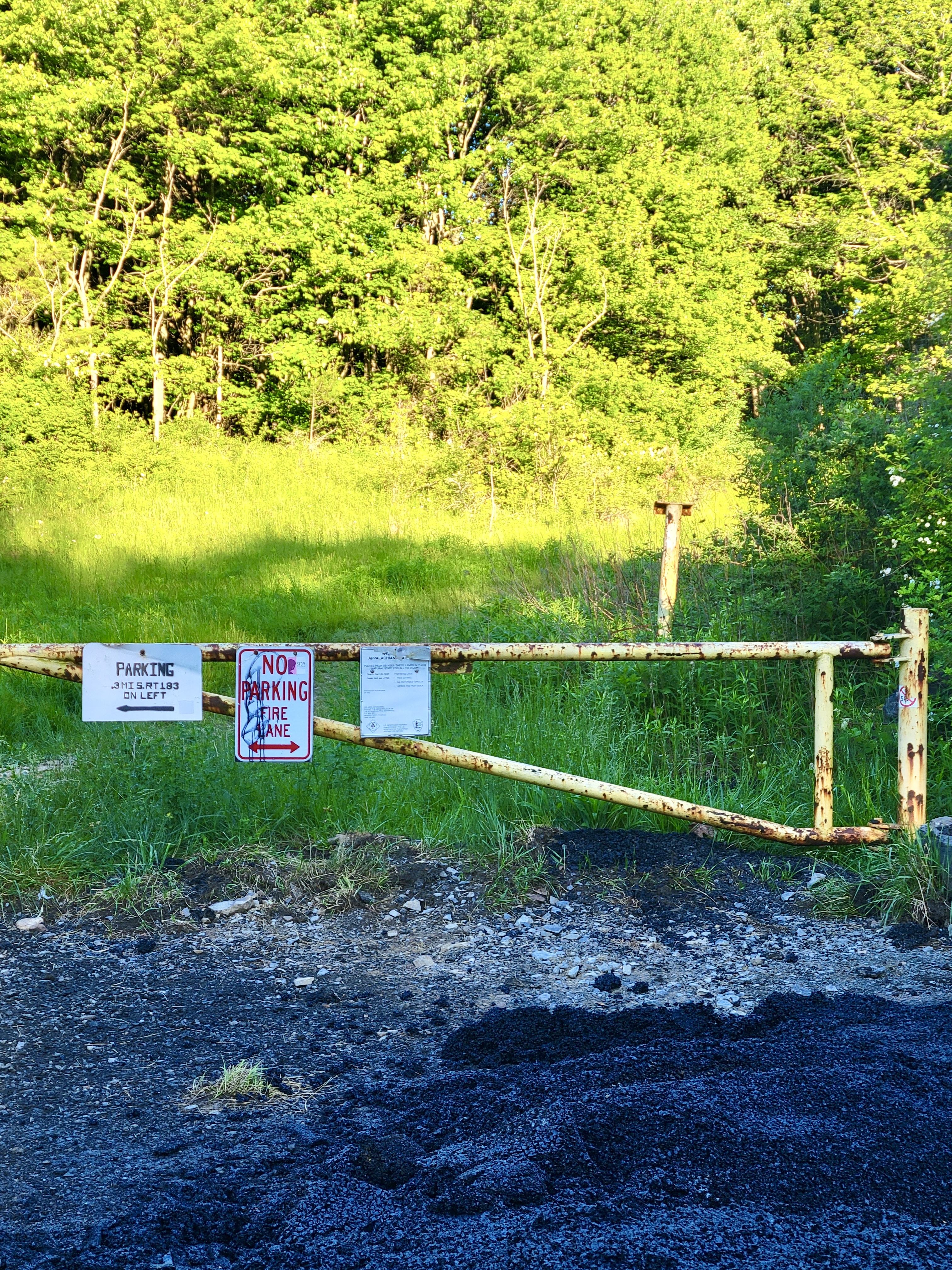 mm 14.4 Pull-off area that can accommodate around 3 vehicles. Note signage directing you to larger gamelot parking area and warning to not park in front of gate  Courtesy cabincellars@yahoo.com