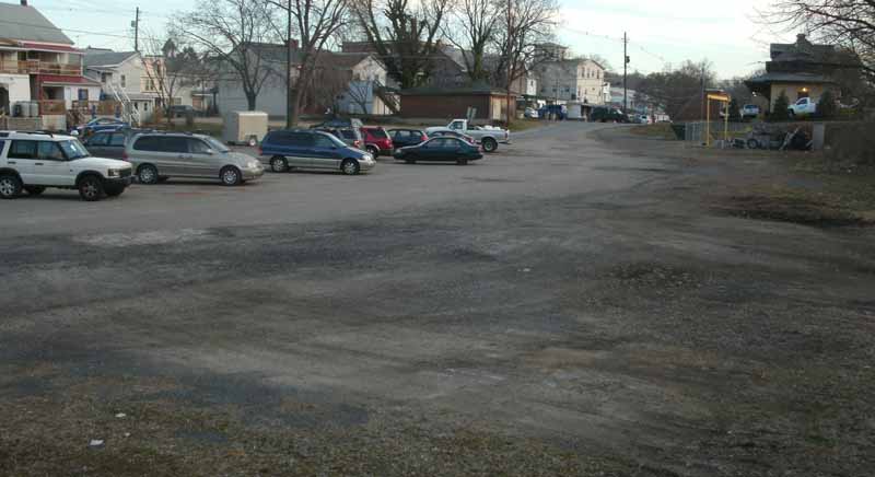 View of parking lot in Duncannon, looking south from Wheeler Field. Space available for several cars. Former railroad station is at upper right.  Courtesy MalteseCross@comcast.net