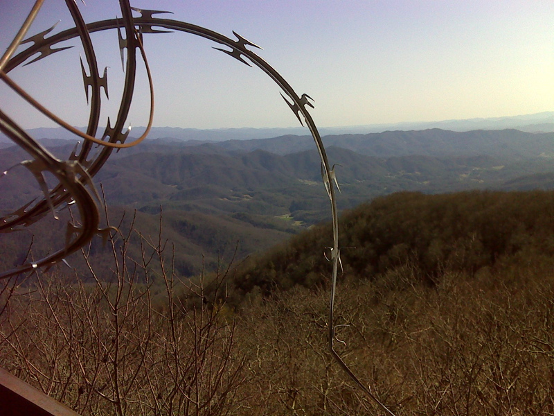 mm 14.1 Vista from steps of closed fire tower on Camp Creek Bald. The concertina wire keeps people from going any higher. GPS N 36.0234  W. 82.7155  Courtesy pjwetzel@gmail.com