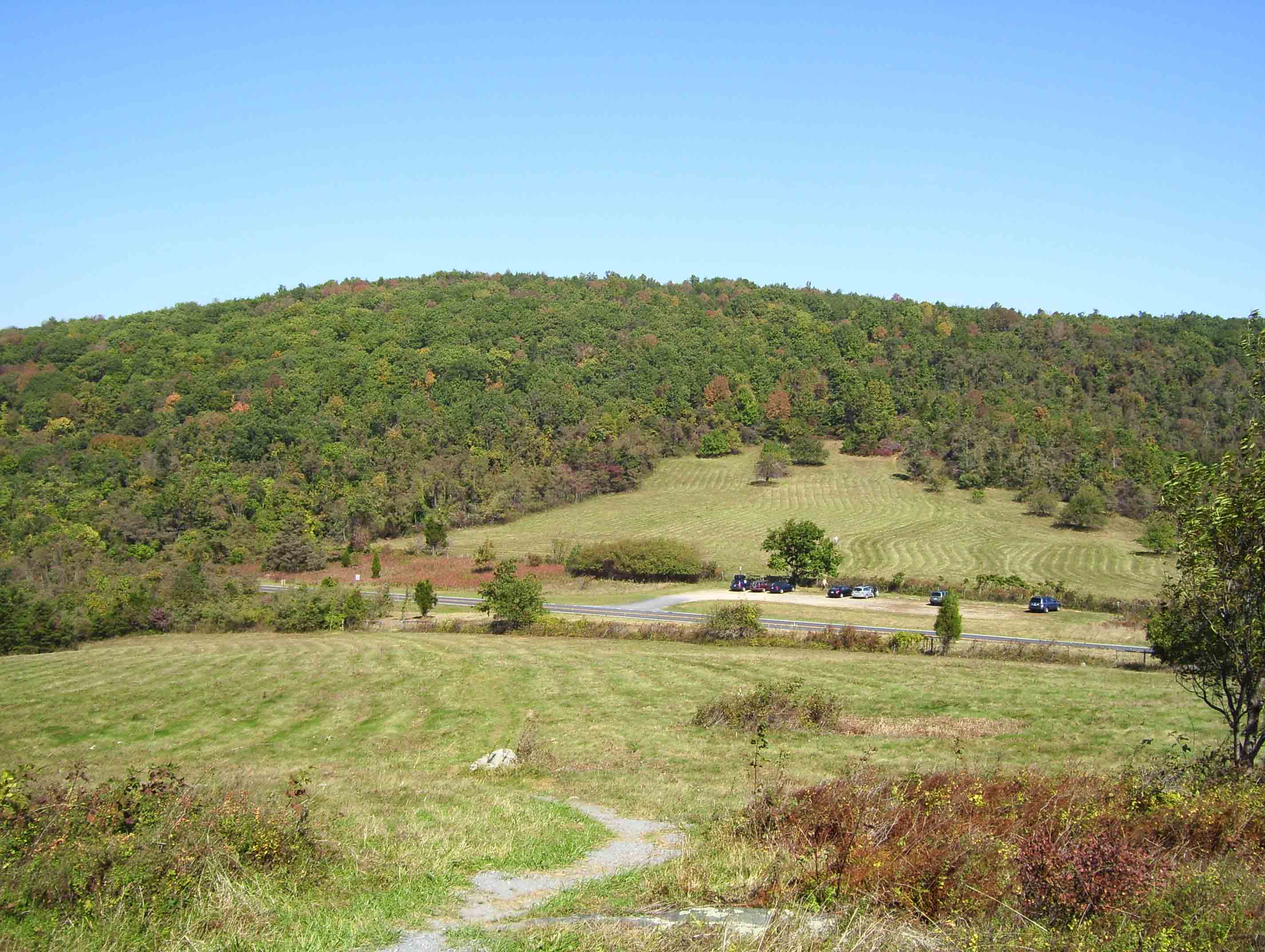 View east across Beagle Gap (Mile 3.2) and the Skyline Drive to Little Calf Mountain. The parking area at Beagle Gap is visible.  Courtesy dlcul@conncoll.edu