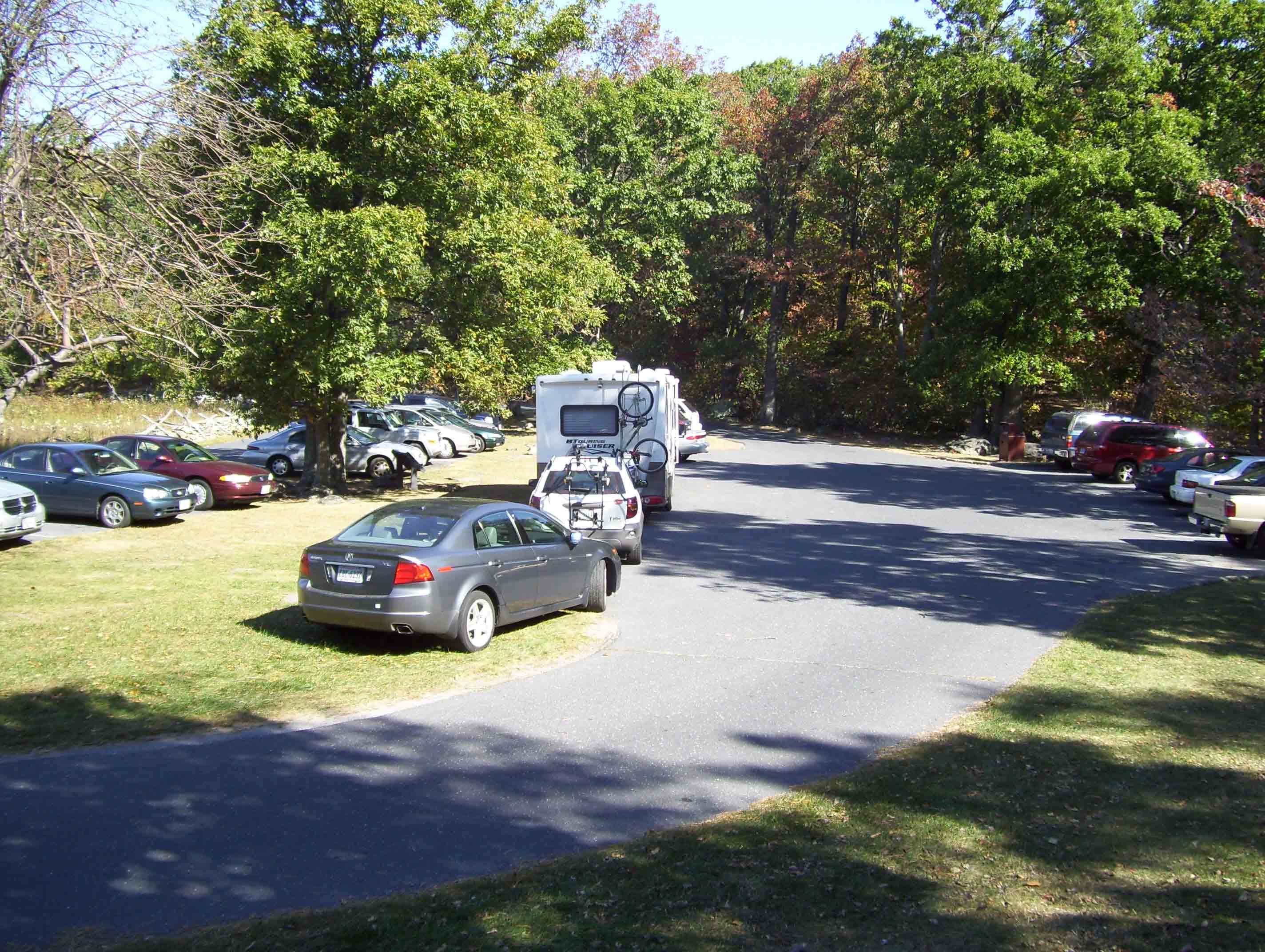 Parking area for Humpback Rocks. From here there is access to the AT at three points. Access to the trail at MM 6.5 follows a blue-blazed trail at the far end of the lot (north). The unblazed access to the trail at MM 7.6 starts just to the right of where the red car in the shade on the right (east) side of the picture was parked when picture was taken. Access to the trail at MM 10.5 follows a blue-blazed trail behind where the picture was taken (south).  Courtesy dlcul@conncoll.edu