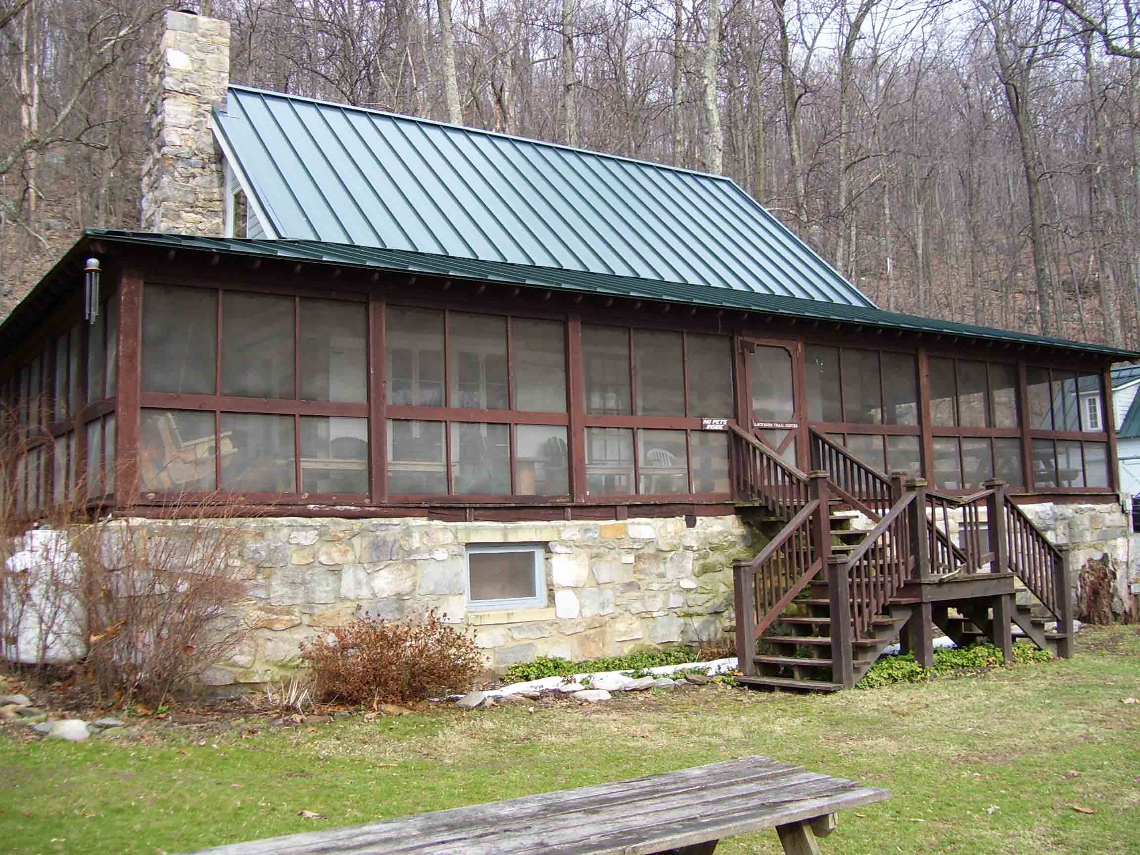 Main building at Blackburn Trail Center, operated by the Potomac Appalachian Trail Club (PATC). There is small bunkhouse which acts as a hostel behind this. Hikers may also camp on the enclosed porch. Water is available.  Courtesy dlcul@conncoll.edu