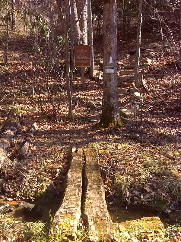 mm 0.0 Footbridge over Possum Jaw Creek immediately south of VA 42 with sign indicating narrow AT corridor on private land easements  Courtesy pjwetzel@gmail.com
