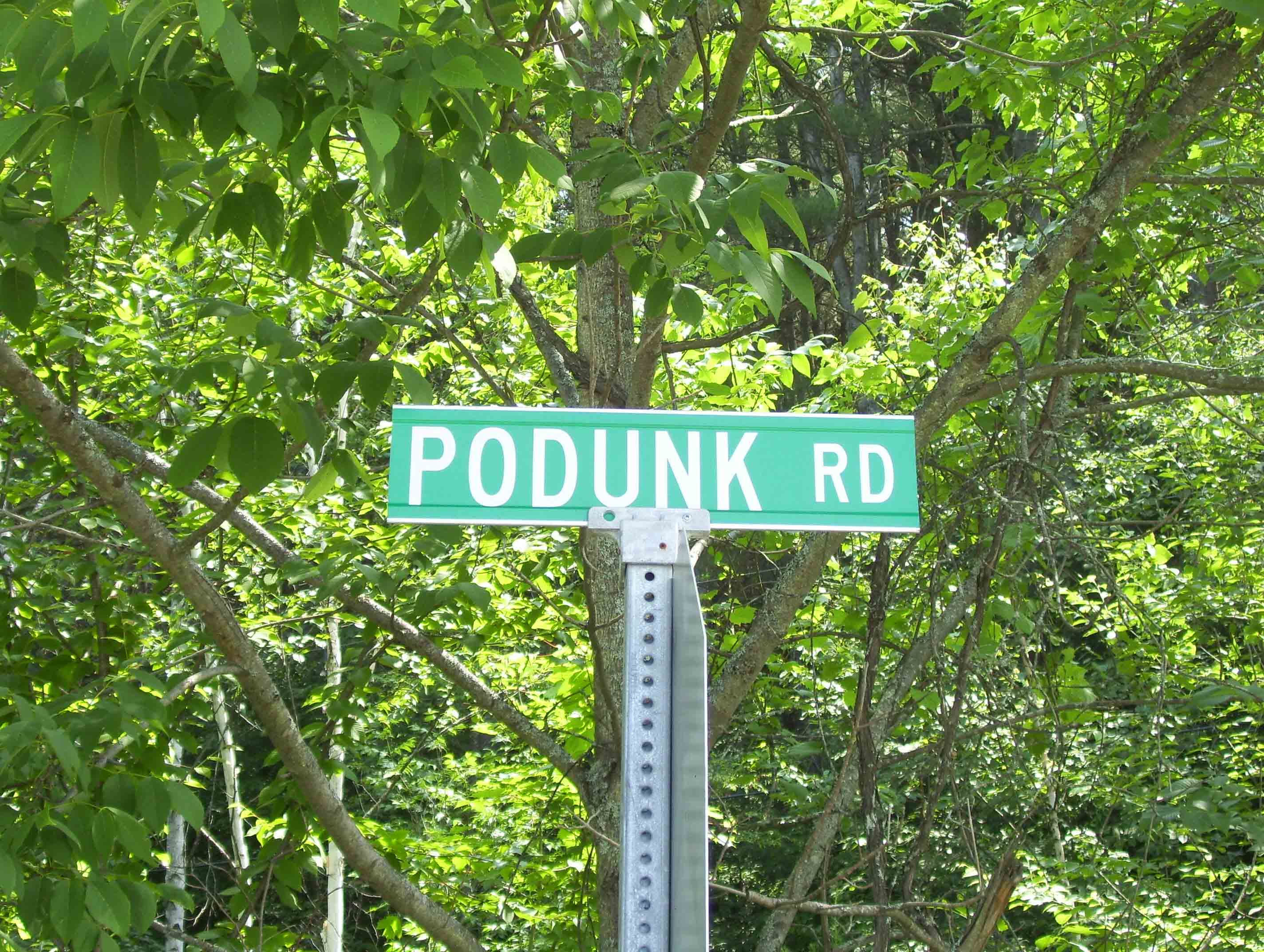 Yes, there is really a Podunk or at least a road by that name. The AT crosses it twice just east (trail north) of West Hartford, VT. This sign is at the crossing at the intersection with Tigertown Road at mm 8.7.   Courtesy dlcul@conncoll.edu