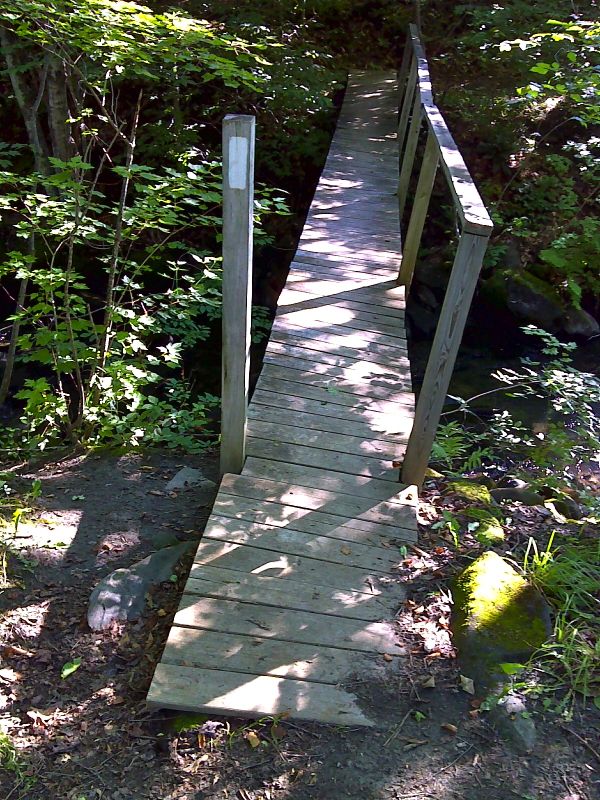 mm 11.1 Footbridge just east (trail north) of Woodstock Stage Road.   GPS N43.6721 W72.5536  Courtesy pjwetzel@gmail.com