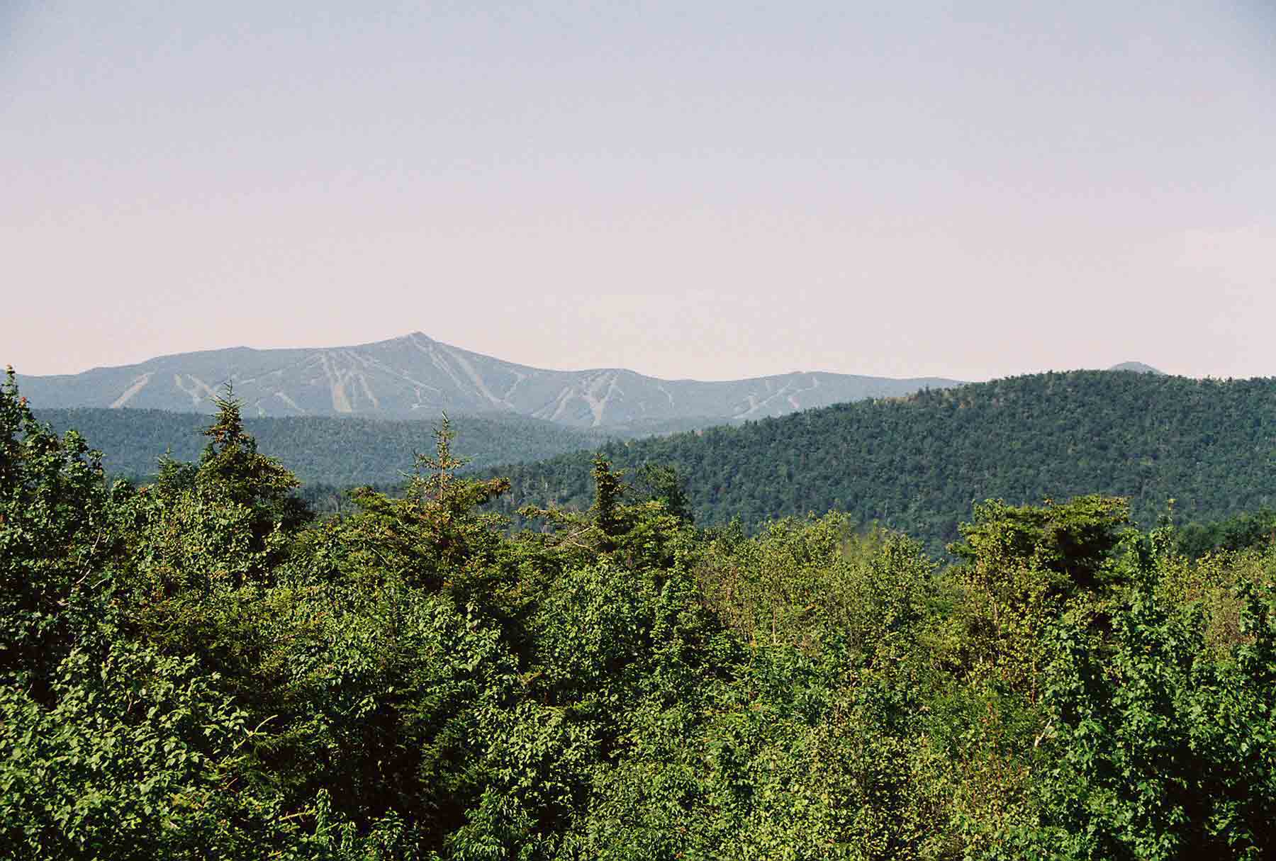 mm 6.2 - A side trail leads from the AT to the Lookout, a cabin which can be used by thru-hikers. There is a ladder to a platform on the roof from which there are 360 degree views. This shot is to the west towards Killington peak.  Courtesy dlcul@conncoll.edu
