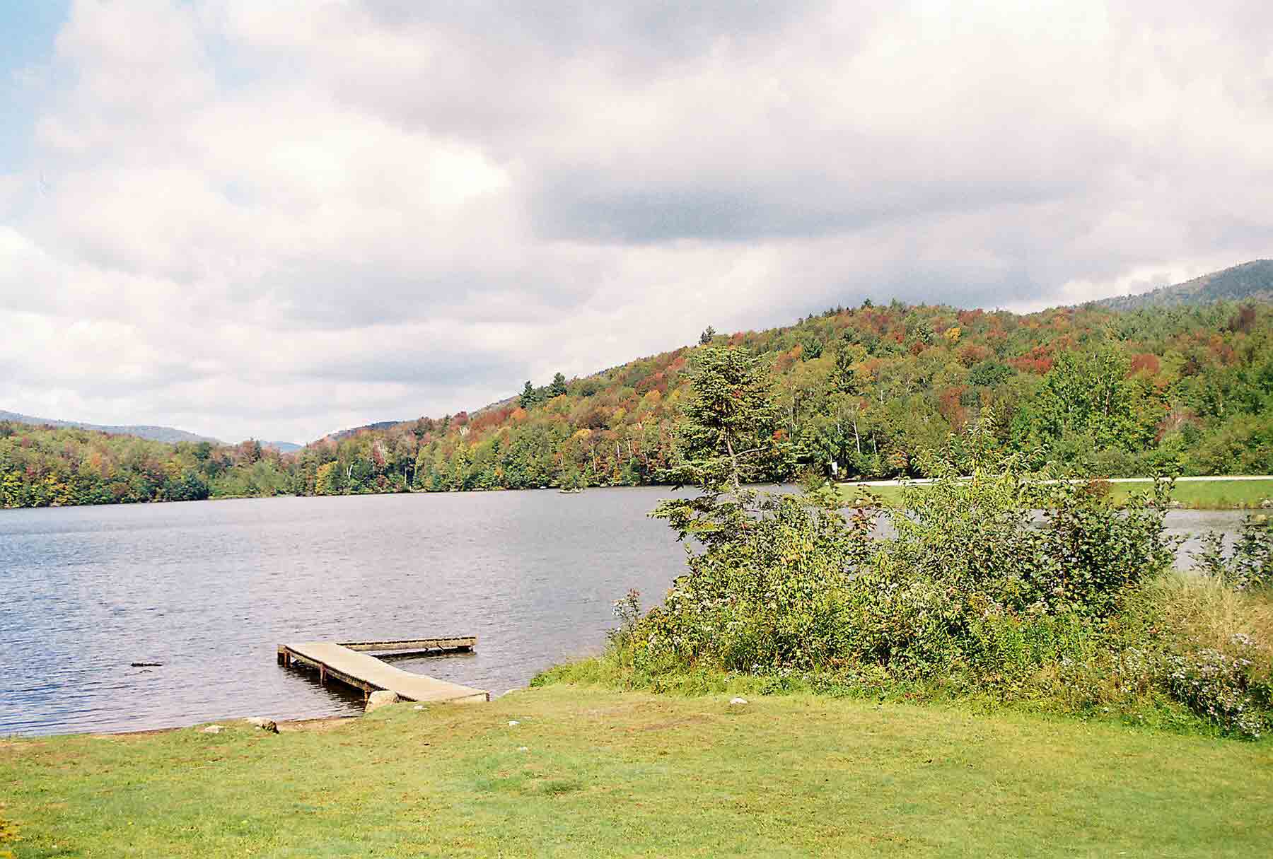 mm 19.7 - Looking north across Kent Pond. The AT runs along the south shore at one point crossing the lawn of Mountain Meadows Lodge. The little dock is for canoes used by their guests.  Courtesy dlcul@conncoll.edu