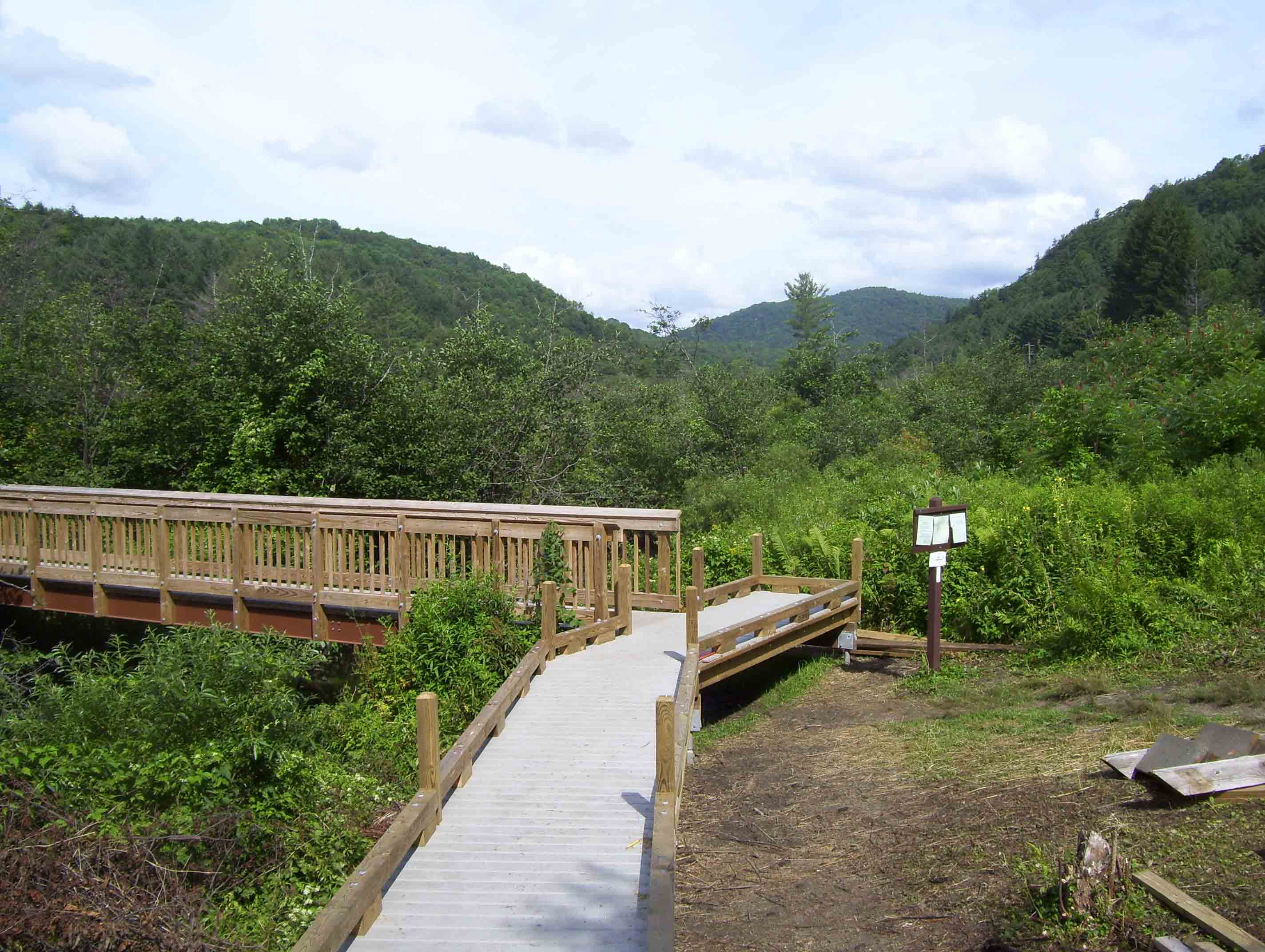 mm 18.0 The new Thundering Brook relocation replaces a road walk west (trail south) of River Road. This reroute required a footbridge (seen in picture) across the Ottauquechee River and an extensive boardwalk to cross the flood plain.  Courtesy dlcul@conncoll.edu