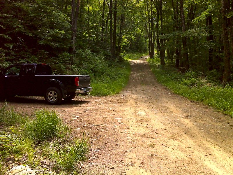 The presence of a truck in this picture indicates that Old Rootville Road  can be used by at least high clearance vehicles from the valley floor to this point.  Whether such use is legal is not known.  Just beyond there is a gate barring further vehicle access.  GPS N43.1523 W73.0059  Courtesy pjwetzel@gmail.com